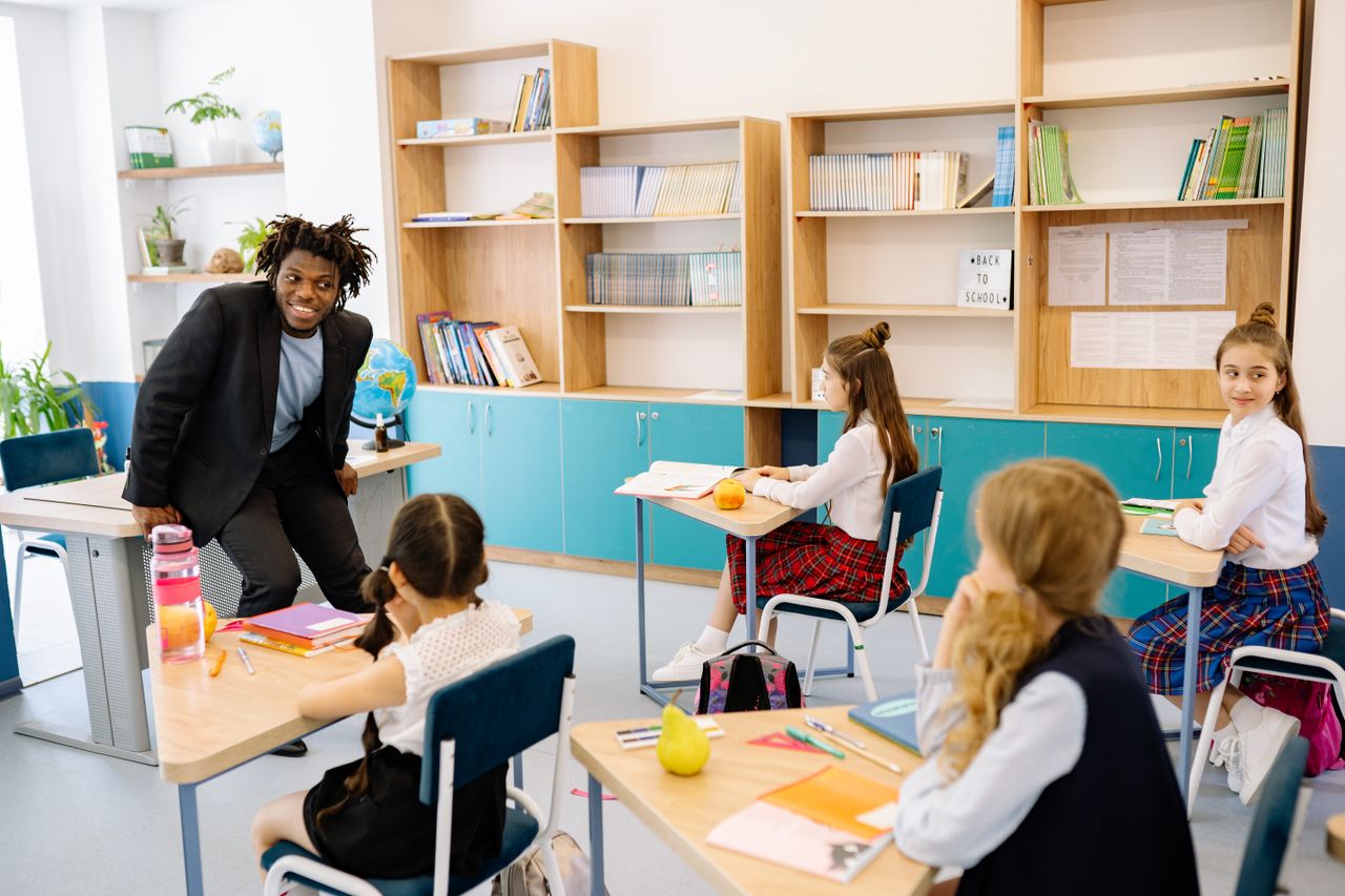 Teacher engaging students in a bright classroom, fostering interactive learning.